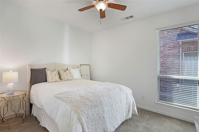 bedroom with carpet floors, visible vents, baseboards, and a ceiling fan