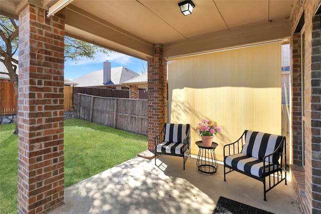 view of patio / terrace featuring fence