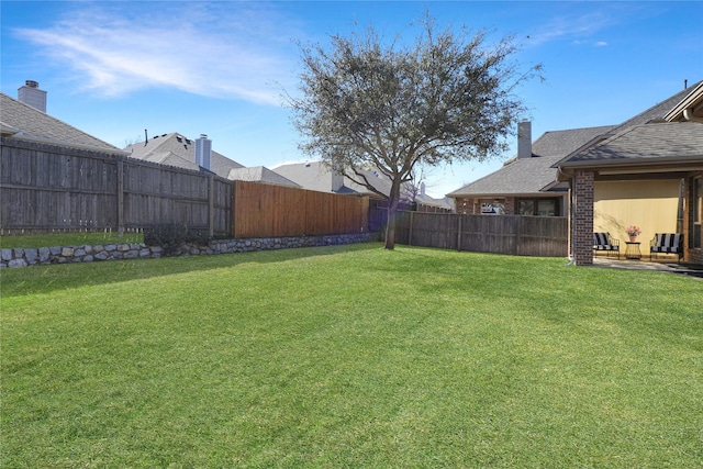 view of yard featuring a fenced backyard