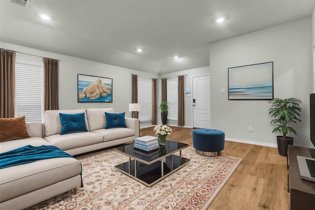 living area featuring baseboards, recessed lighting, and light wood-style floors