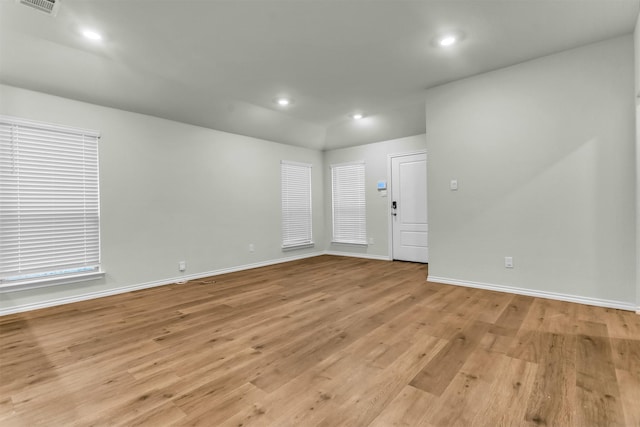 spare room featuring baseboards, recessed lighting, visible vents, and light wood-style floors