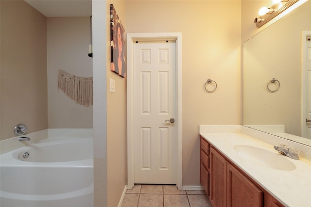 full bath featuring baseboards, vanity, a bath, and tile patterned floors