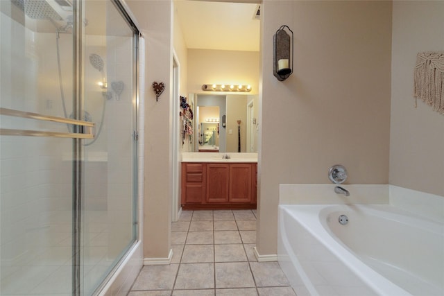 full bathroom featuring a garden tub, a shower stall, vanity, tile patterned flooring, and baseboards