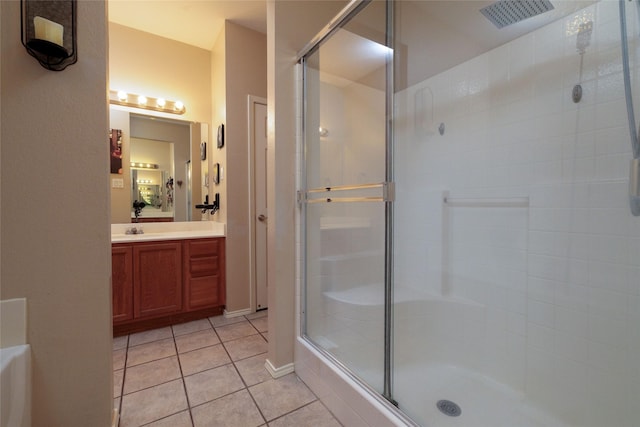 bathroom featuring a stall shower, vanity, and tile patterned floors