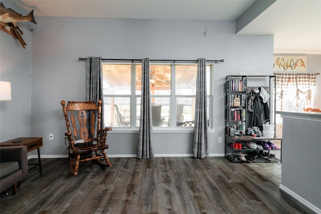 living area featuring baseboards and wood finished floors