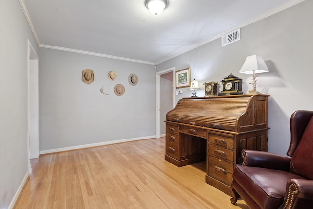 office space featuring visible vents, baseboards, light wood-style flooring, and crown molding