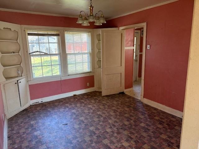 unfurnished dining area with a chandelier, crown molding, and baseboards