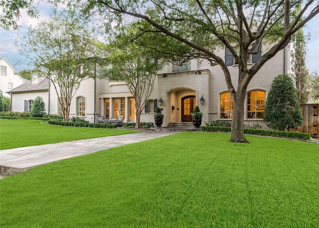 mediterranean / spanish-style house featuring driveway and a front lawn