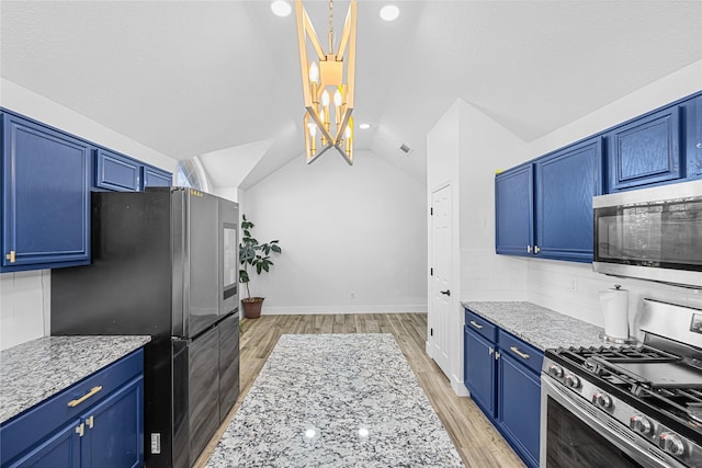 kitchen featuring light wood finished floors, tasteful backsplash, blue cabinets, vaulted ceiling, and stainless steel appliances