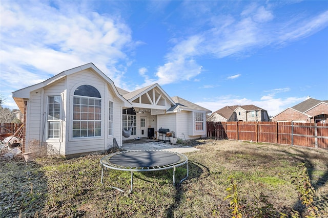 back of property featuring a fenced backyard