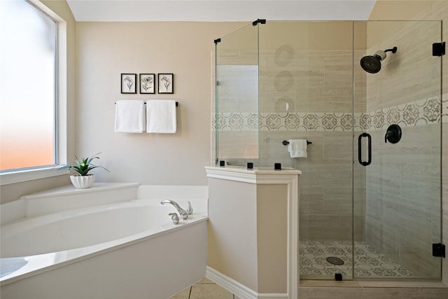 bathroom with a stall shower and a bath