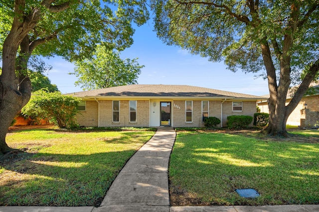 ranch-style house with brick siding and a front yard