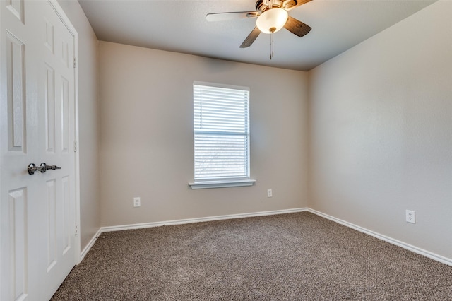 carpeted empty room featuring ceiling fan and baseboards