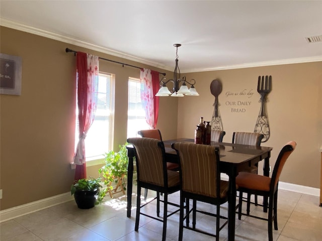 dining area with visible vents, baseboards, ornamental molding, light tile patterned floors, and an inviting chandelier