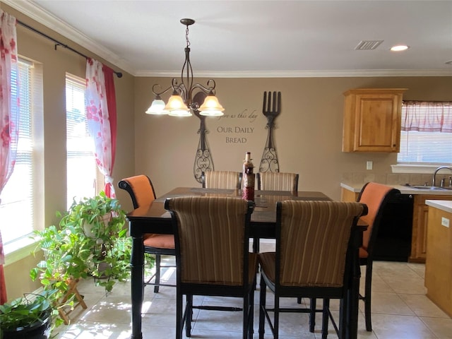 dining area with light tile patterned floors, a chandelier, and ornamental molding