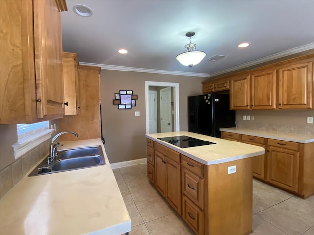 kitchen with visible vents, black appliances, a sink, a center island, and crown molding