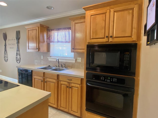 kitchen with light tile patterned floors, ornamental molding, a sink, black appliances, and light countertops