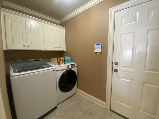 washroom featuring light tile patterned floors, baseboards, cabinet space, separate washer and dryer, and ornamental molding