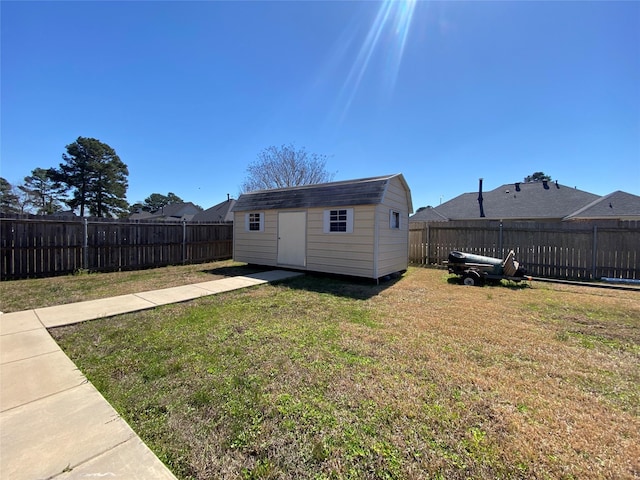 view of yard featuring a fenced backyard, a shed, and an outdoor structure