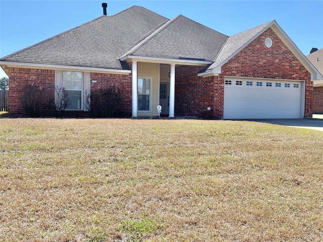 view of front facade with a front yard, brick siding, and roof with shingles