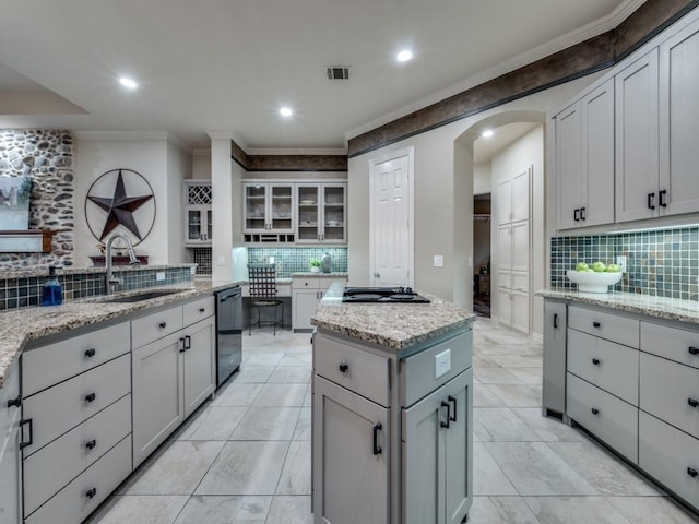 kitchen featuring visible vents, arched walkways, ornamental molding, black appliances, and a sink