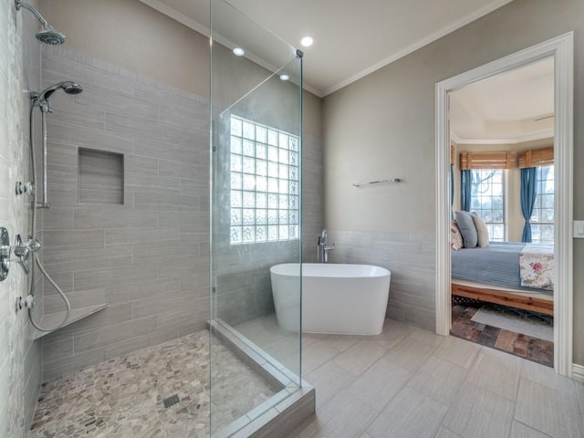 full bath with ensuite bathroom, tiled shower, a freestanding tub, and crown molding