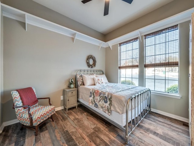 bedroom with ceiling fan, baseboards, and wood finished floors