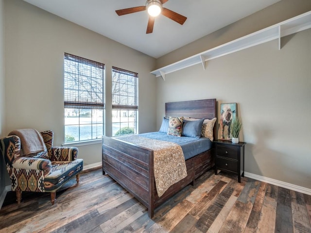 bedroom featuring a ceiling fan, wood-type flooring, and baseboards