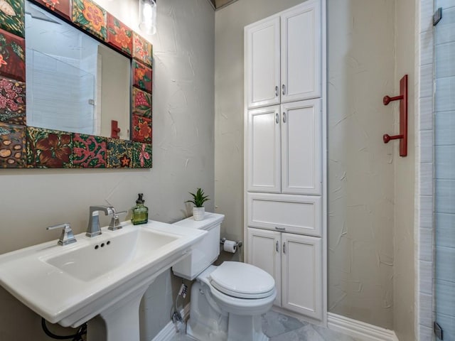 bathroom with toilet and a sink