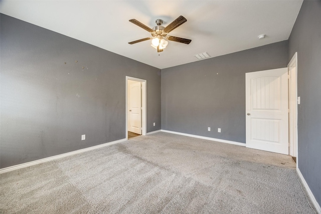 unfurnished bedroom featuring a ceiling fan, visible vents, baseboards, and carpet flooring