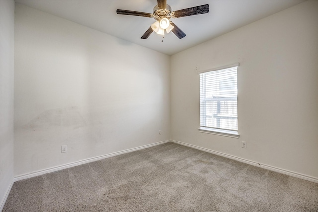 spare room with carpet flooring, a ceiling fan, and baseboards