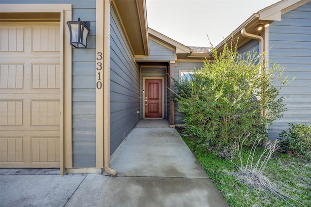 doorway to property with a garage