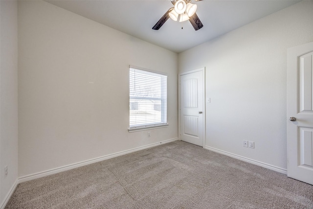 empty room with ceiling fan, baseboards, and carpet flooring