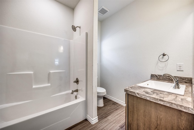 full bathroom featuring shower / bathtub combination, visible vents, toilet, vanity, and wood finished floors