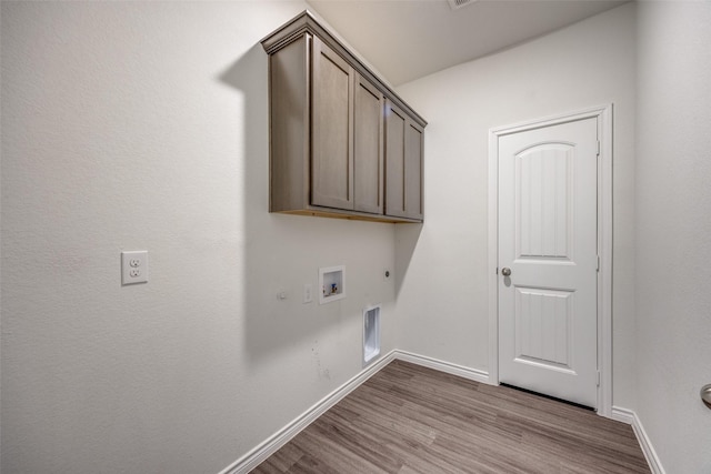 clothes washing area featuring baseboards, dark wood-style flooring, electric dryer hookup, and hookup for a gas dryer