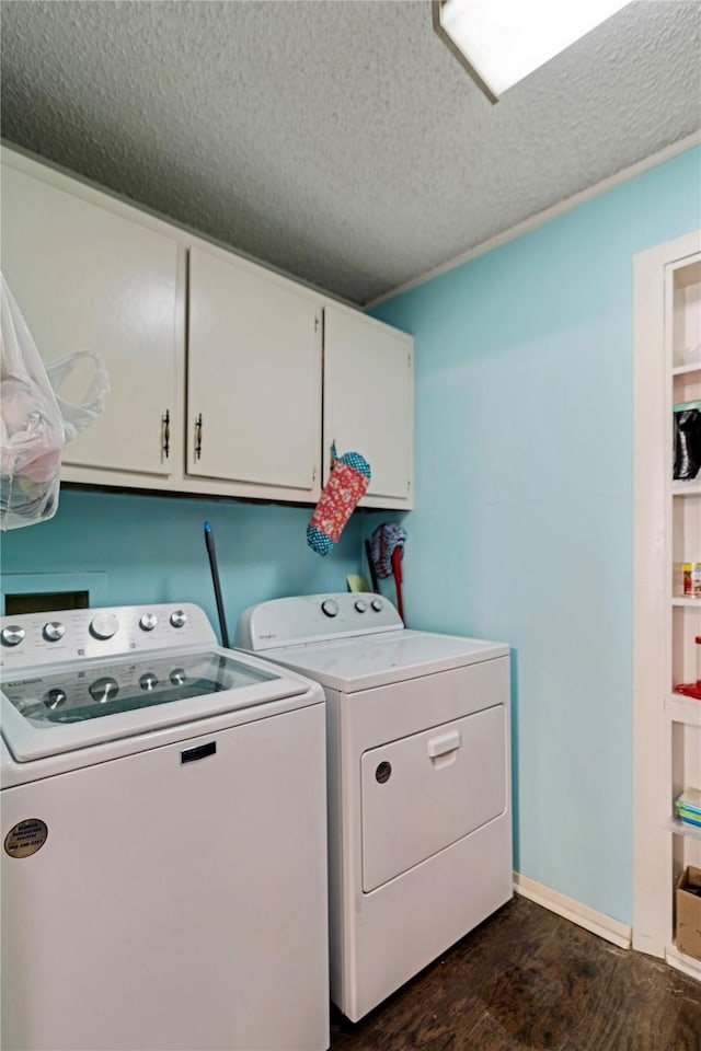 clothes washing area featuring cabinet space, washing machine and dryer, a textured ceiling, and dark wood-type flooring