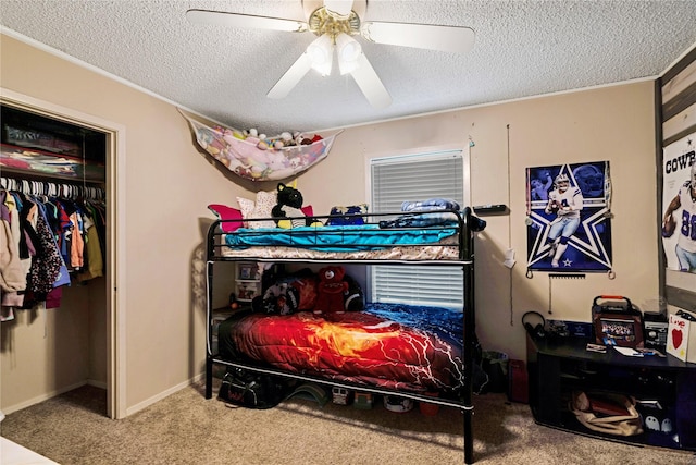 carpeted bedroom featuring a textured ceiling, ceiling fan, and baseboards