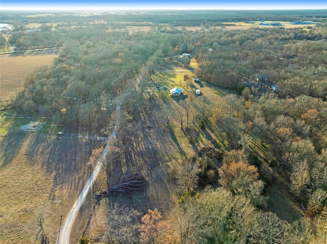 drone / aerial view featuring a wooded view