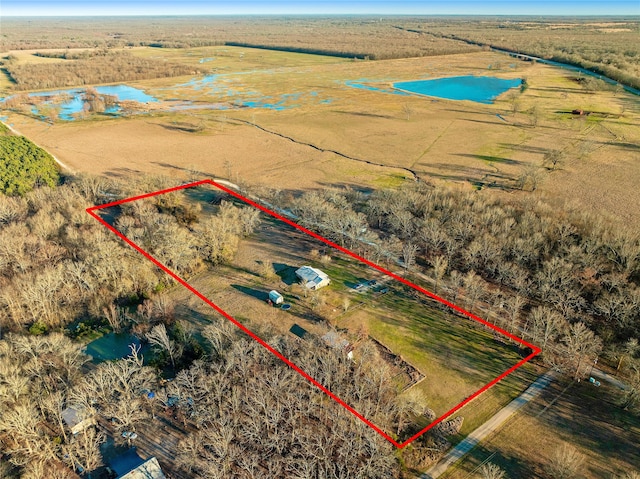 drone / aerial view featuring a water view and a rural view