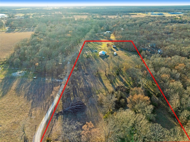 birds eye view of property with a view of trees