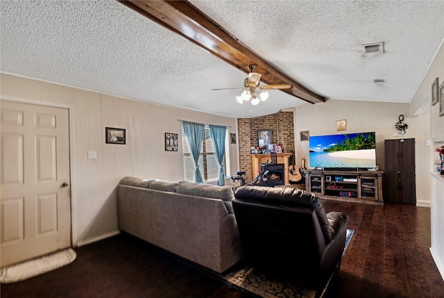 living room with a fireplace, visible vents, lofted ceiling with beams, ceiling fan, and wood finished floors