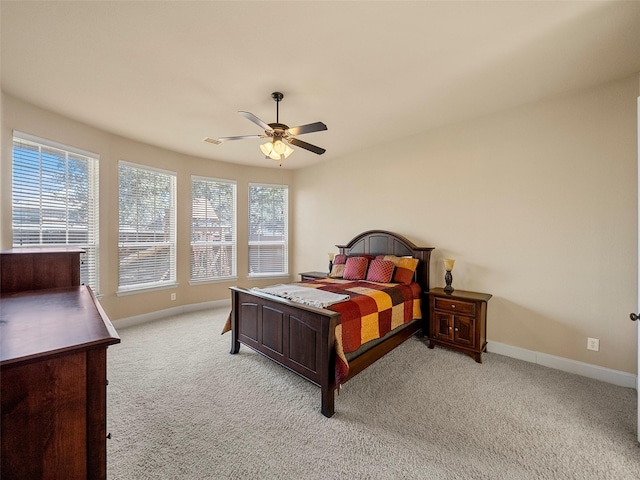 bedroom featuring light carpet, baseboards, and a ceiling fan