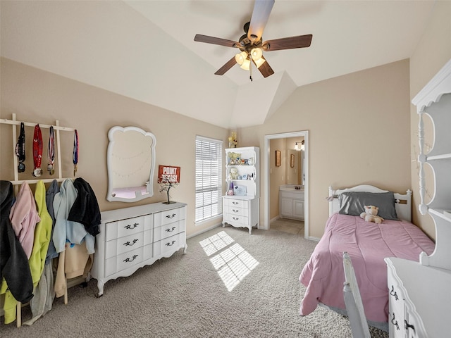 bedroom with a ceiling fan, lofted ceiling, light colored carpet, and ensuite bathroom