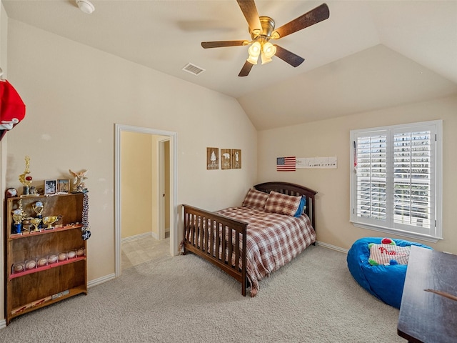 carpeted bedroom with ceiling fan, baseboards, visible vents, and vaulted ceiling