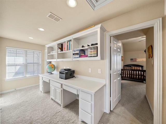 home office with built in desk, recessed lighting, visible vents, and light colored carpet