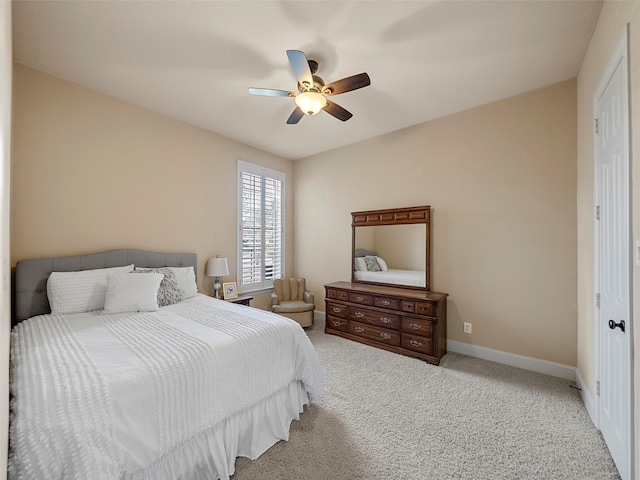 bedroom with ceiling fan, carpet, and baseboards