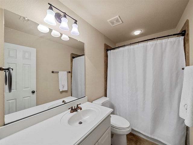 full bathroom featuring tile patterned flooring, visible vents, vanity, and toilet