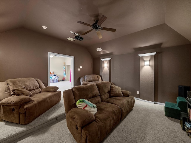 home theater featuring lofted ceiling, ceiling fan, and light colored carpet