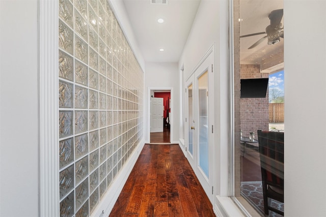 hallway with visible vents, wood finished floors, and recessed lighting