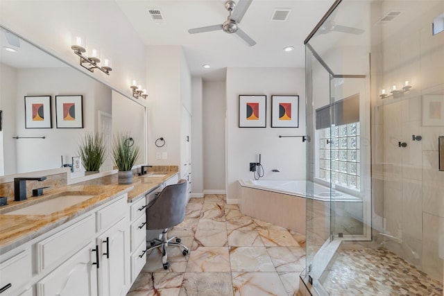 full bath featuring a garden tub, marble finish floor, a sink, a shower stall, and double vanity